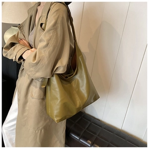 Detailed texture of olive green faux leather hobo bag with smooth glossy finish