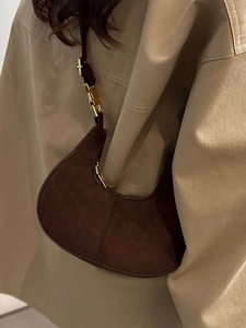 Retro dark brown matte crescent handbag with gold bamboo buckle and minimalist aesthetic