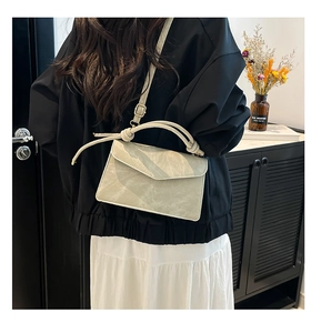 Detailed view of sage green gradient crossbody bag with a unique knot handle and strap