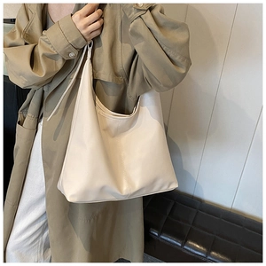 Close-up of minimalist cream white tote bag with vertical stitching for daily commute