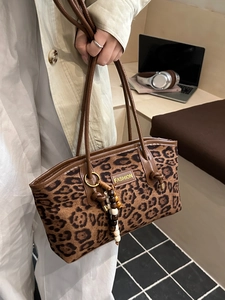 Vintage leopard print suede tote bag with brown leather handles and beaded charm