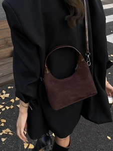 Retro dark brown suede tote bag with chain strap shown on model in autumn street setting