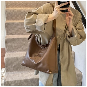 Detailed view of the dark brown PU leather Hobo bag with vertical stitching and wide strap