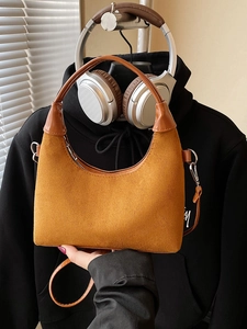 Retro mustard yellow faux suede crescent tote bag with brown leather handles and silver zip