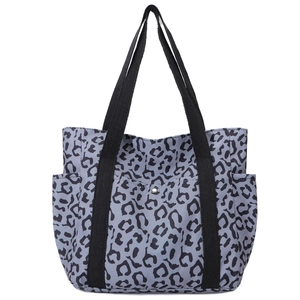 Large leopard print canvas tote bag with black handles and multiple outer pockets