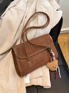 Brown frosted suede shoulder bag for women featuring a cute teddy bear charm