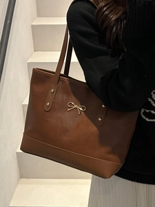 Chic dark brown tote bag with gold bow decoration and large capacity for daily use