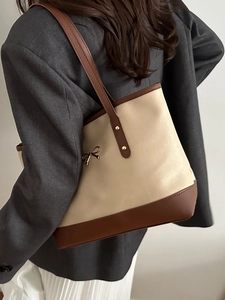 Fashionable bow-knot tote bag in cream white and brown faux leather with gold accents