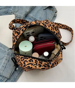 Detail showing the large interior capacity of this leopard print canvas shoulder bag