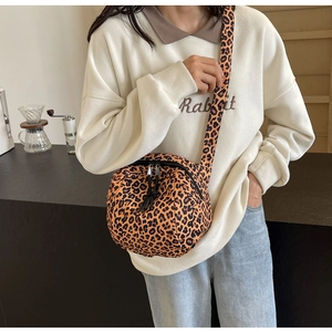 Detail of leopard print crossbody bag with wide shoulder strap and double zip closure