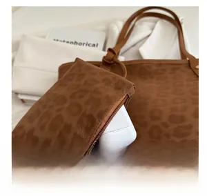 Close-up of leopard print tote bag with a small matching zip pouch for wireless earphones