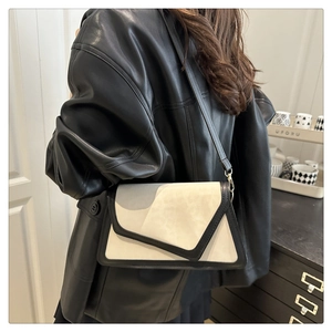 Detail view of a geometric color-block crossbody bag on a model for daily casual styling