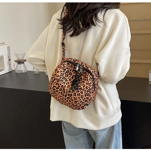 Rear view of a stylish leopard print crossbody bag worn as a trendy chest pack