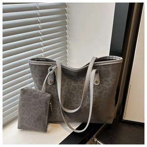 Detail view of charcoal leopard tote bag set with matching zipper pouch and rivets