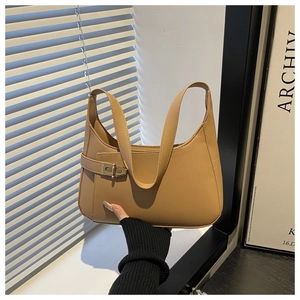 Detail of khaki crescent underarm bag with smooth leather finish and metal buckle strap