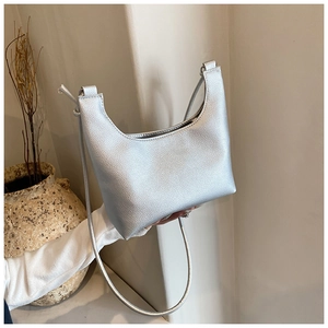 Detail of silver hobo bag featuring premium lychee grain texture and minimalist slim strap