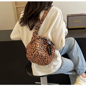 Detailed view of leopard print canvas crossbody bag with adjustable black shoulder strap
