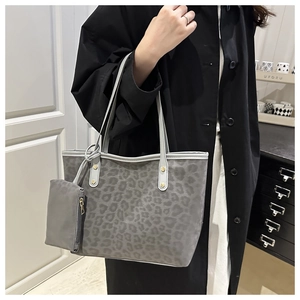 Detail of grey leopard print tote bag with matching mini pouch and gold hardware