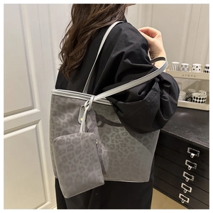 Detail of grey leopard print tote bag with matching pouch shown on shoulder
