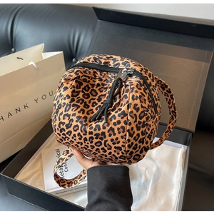 Detailed close-up of leopard print nylon mini bag in a luxury gift box packaging