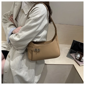 Chic camel leather underarm bag styled with a beige trench coat for a daily commute look