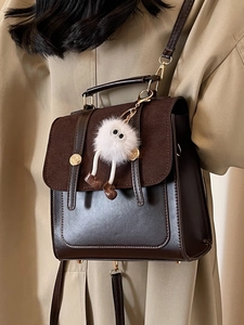 Chic brown leather backpack and handbag for women featuring a plush charm decoration