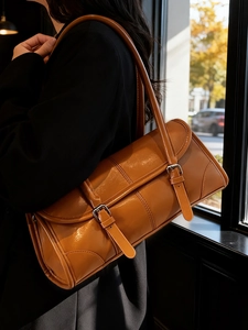 Vintage tan underarm bag in premium PU leather with buckle detail and minimalist design