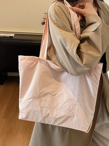 Minimalist soft pink embroidered tote bag with stylish heart and star pattern details