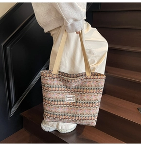 Detailed close-up of ethnic tote bag with woven geometric patterns and durable straps