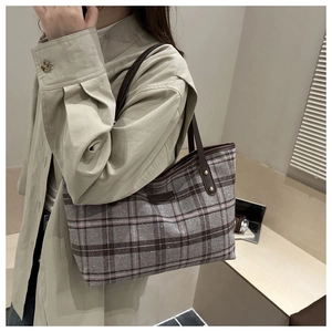 Detail of retro plaid tote bag with premium leather handles and metal rivet reinforcement