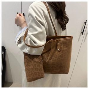 Detailed view of large leopard print tote bag and matching pouch for daily commute