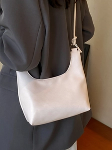 Creamy white lychee-textured hobo shoulder bag with stylish knotted strap detail