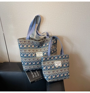 Detail of ethnic geometric patterned tote bags on a sofa with an art design book