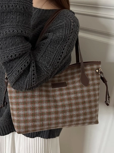 Chic plaid tote bag with orange and green tweed pattern and brown leather straps