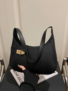 Minimalist black hobo shoulder bag with matte leather finish and golden metal buckle