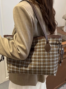 Elegant plaid tote bag with brown leather trim and tassels for stylish commute