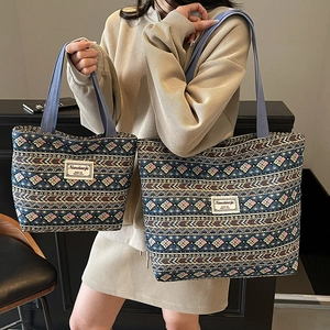 Ethnic style jacquard tote bags with wide straps for women in two sizes shown by model