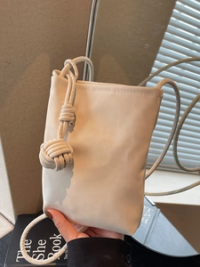 Minimalist cream crossbody mobile phone bag with woven decorative ball and thin rope strap