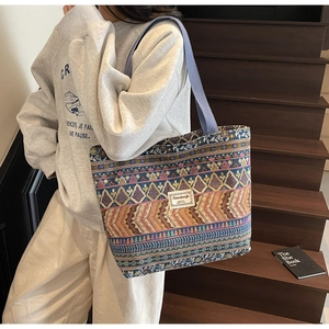Detail of multi-color geometric woven tote bag with durable strap and logo patch