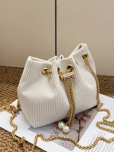 Chic cream corduroy bucket bag with pearl drawstring and golden chain strap detail