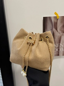 Chic beige corduroy bucket bag with gold chain strap and pearl drawstring details