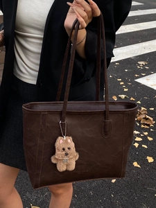 Large dark brown tote bag in vintage faux leather with plush puppy charm for women