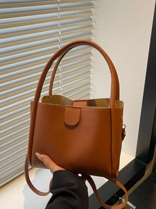 Minimalist caramel brown bucket bag with lychee texture for office and daily commuting