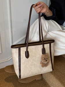 Large capacity cream tote bag with dark brown trim and cute plush bear charm for daily use