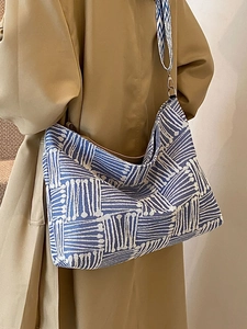Blue and white woven large tote bag with wide strap and urban hobo silhouette