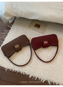 Detail of suede underarm bags featuring golden horsebit hardware and vintage textures