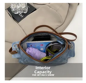 Detail view of denim handbag interior capacity holding tablet, umbrella and phone