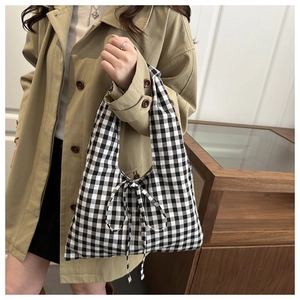 Classic black and white gingham tote bag featuring a decorative bow tie detail