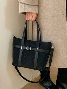 Classic black woven texture tote bag with leather straps and decorative metal buckle