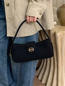 Minimalist black baguette shoulder bag with gold horsebit buckle and sleek strap